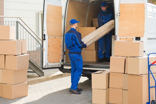 Professional flat removal team handling boxes in Queenspark
