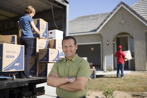 Commercial moving team handling office equipment during a Queenspark relocation